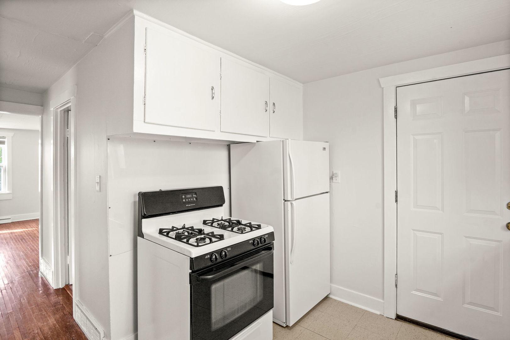 827 East Wilson Street, Unit B Batavia, IL 60510 - Photo 9 of 17 a white refrigerator freezer and a stove sitting inside of a kitchen