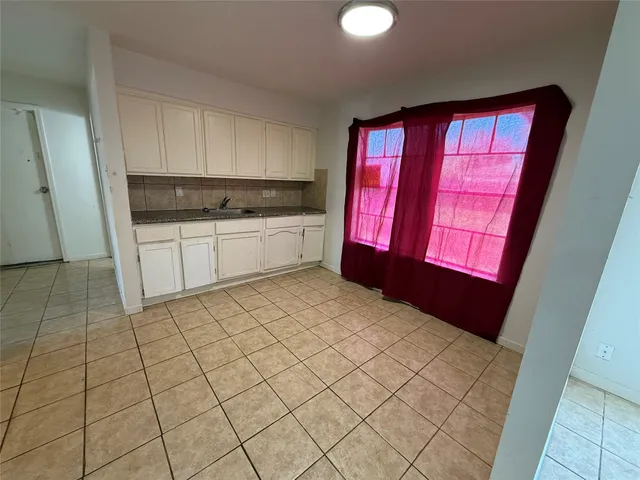 a kitchen with a refrigerator a stove top oven