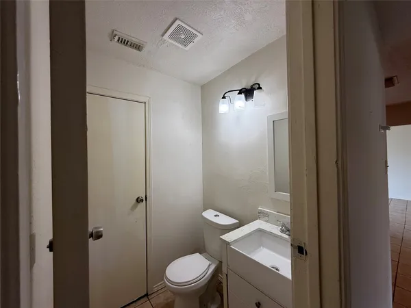 a bathroom with a toilet a sink and shower