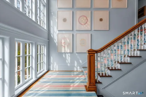 a view of entryway and hall with wooden floor