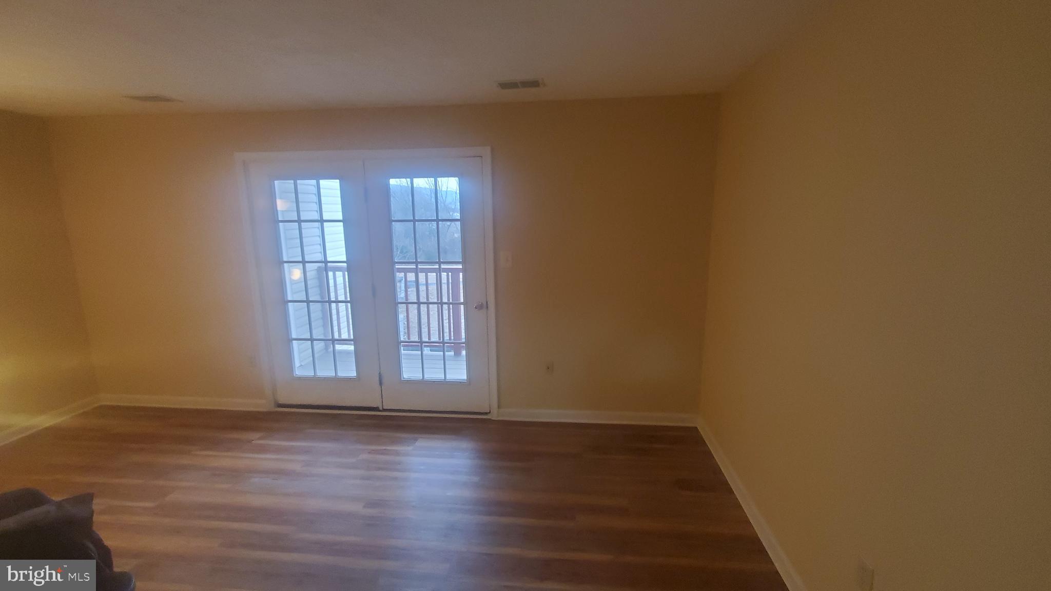 1292 South Ox Road Woodstock, VA 22664 - Photo 24 of 24 an empty room with wooden floor and windows