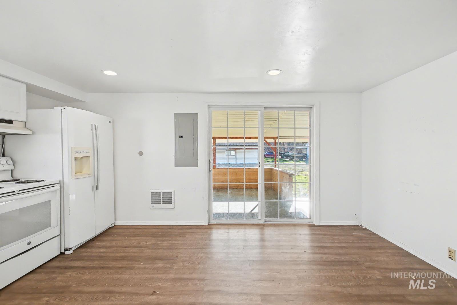 1830 Columbia Street Pomeroy, WA 99347 - Photo 11 of 28 Kitchen featuring white range with electric cooktop, dark wood-style floors, electric panel, custom exhaust hood, and recessed lighting