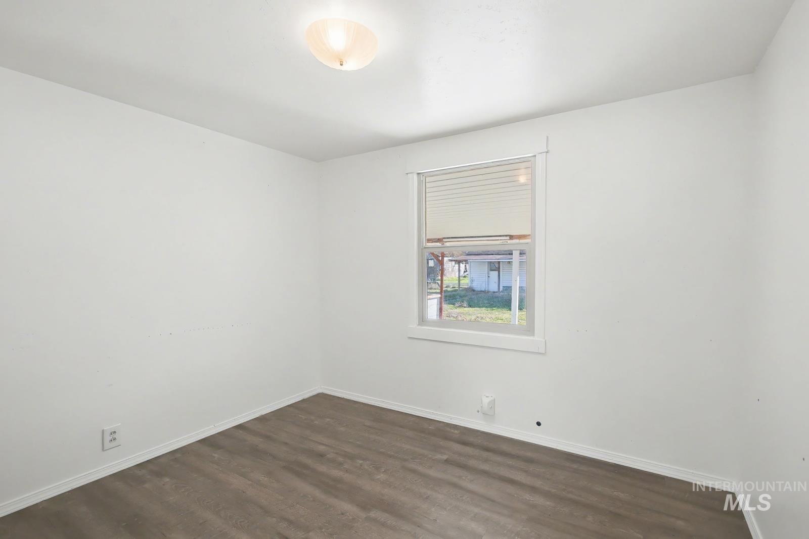 1830 Columbia Street Pomeroy, WA 99347 - Photo 12 of 28 Empty room featuring dark wood-style floors and baseboards