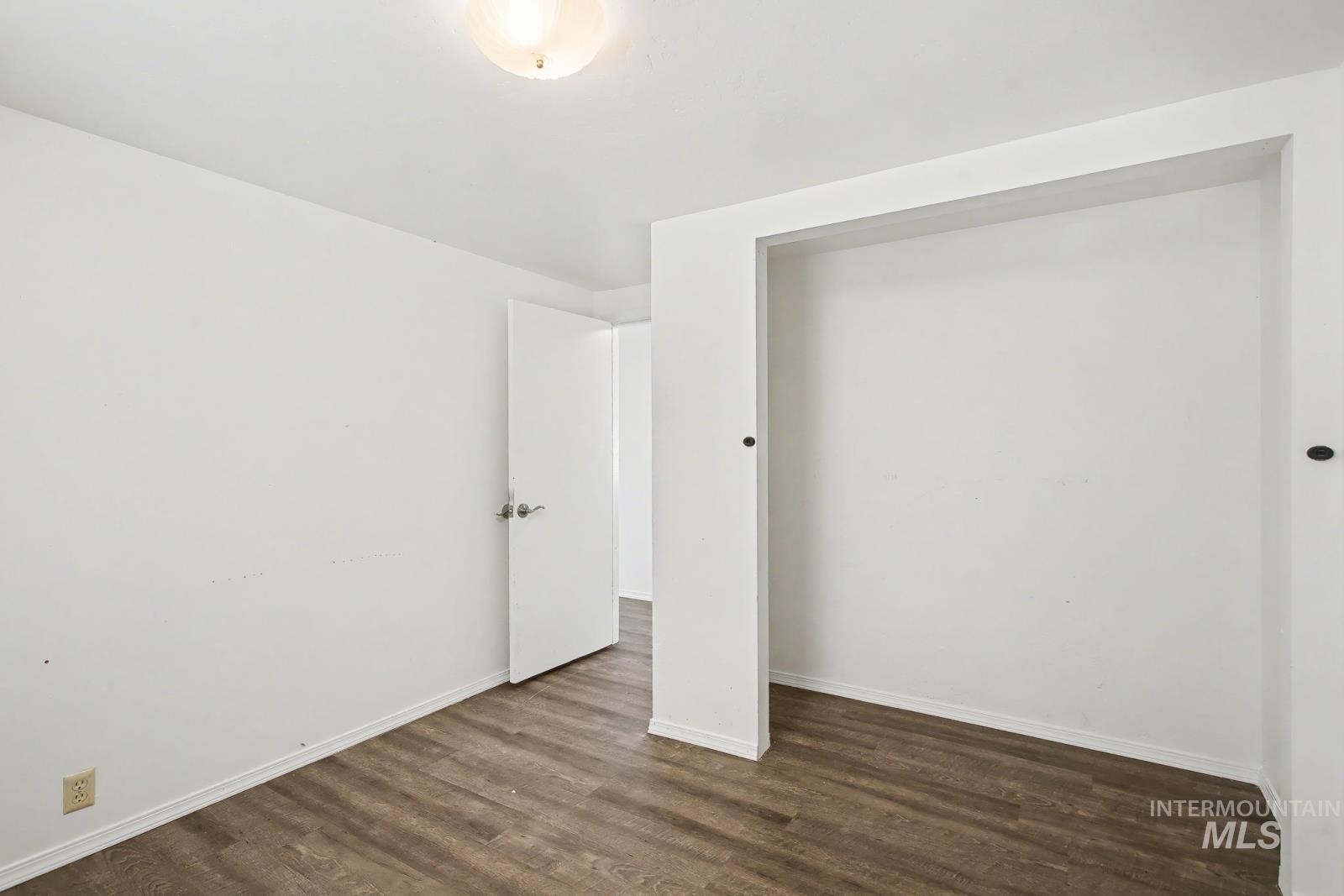 1830 Columbia Street Pomeroy, WA 99347 - Photo 13 of 28 Unfurnished bedroom featuring dark wood-style floors and baseboards