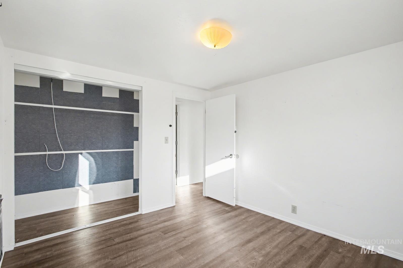 1830 Columbia Street Pomeroy, WA 99347 - Photo 19 of 28 Unfurnished bedroom featuring a closet and dark wood-style floors