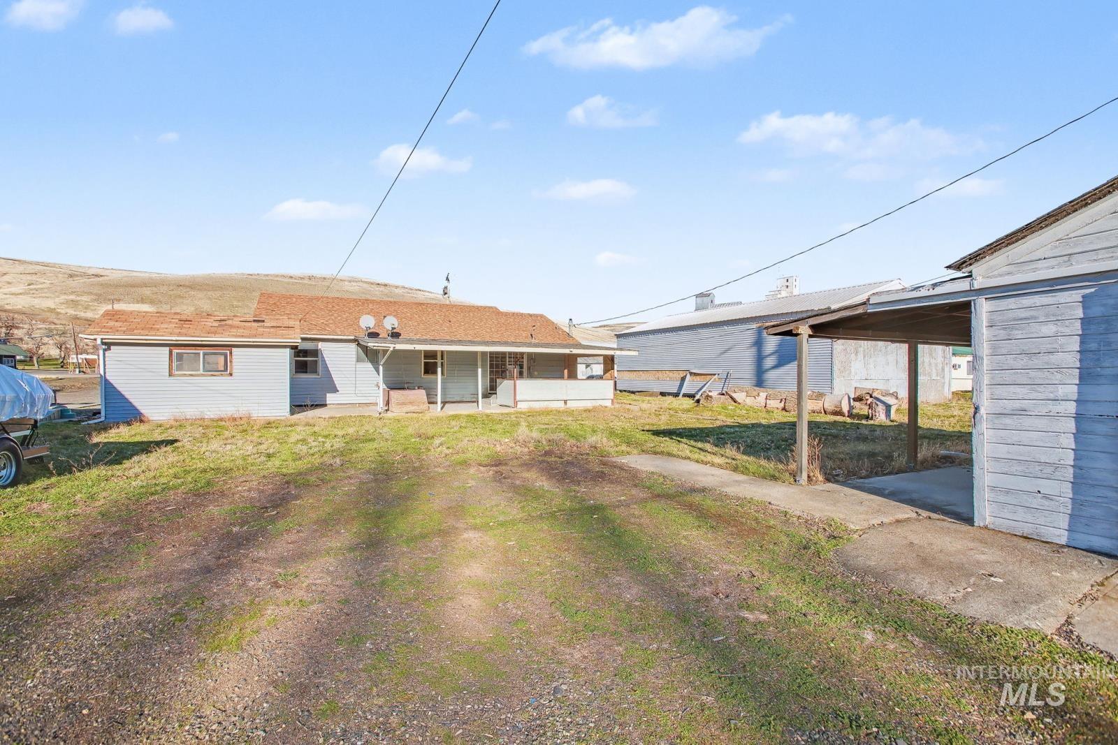 1830 Columbia Street Pomeroy, WA 99347 - Photo 24 of 28 Back of house with a patio area and a lawn