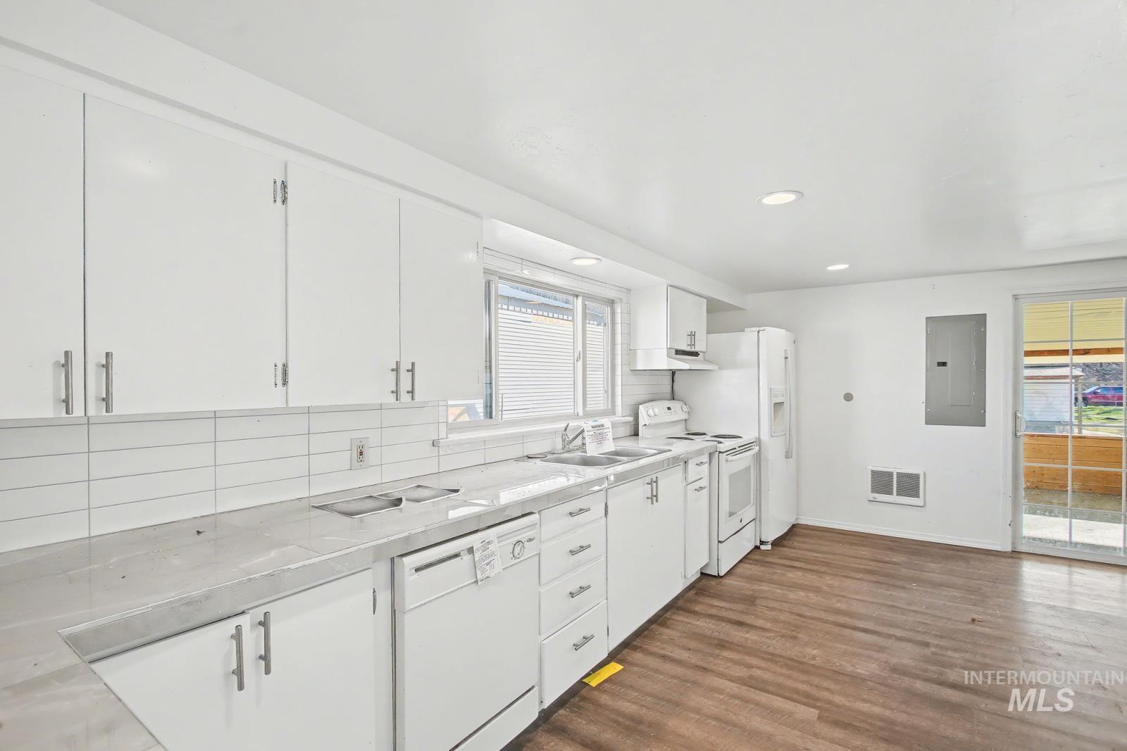 1830 Columbia Street Pomeroy, WA 99347 - Photo 7 of 28 Kitchen with white appliances, decorative backsplash, white cabinets, light countertops, and recessed lighting