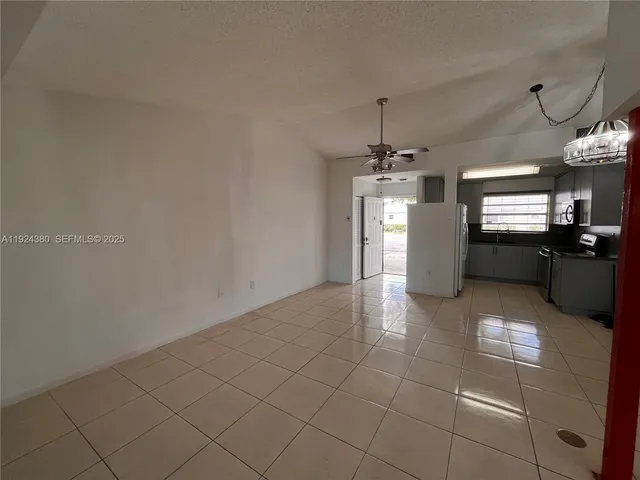 a view of a kitchen with granite countertop cabinets