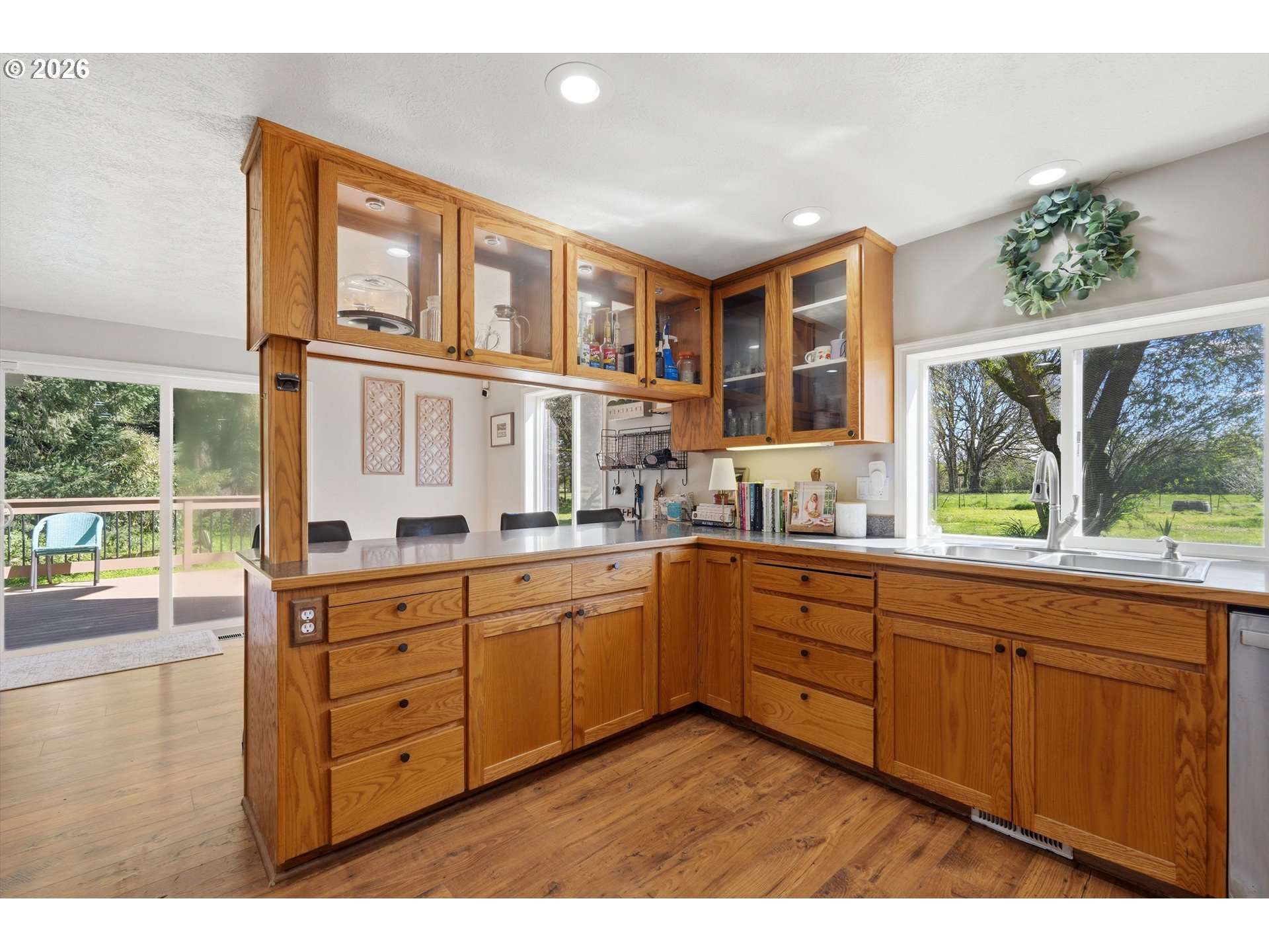 23032 Northeast Hagey Road Dundee, OR 97115 - Photo 13 of 42 a kitchen with granite countertop a sink cabinets wooden floor and a window