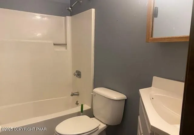 a white toilet sitting next to a bath tub