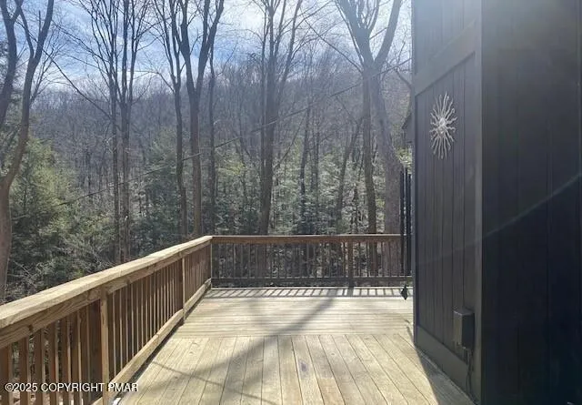 an empty room with windows and fireplace