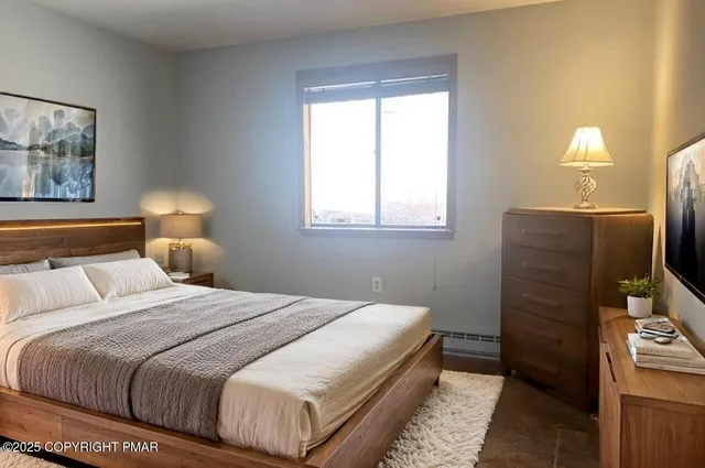 a bedroom with a bed and a lamp