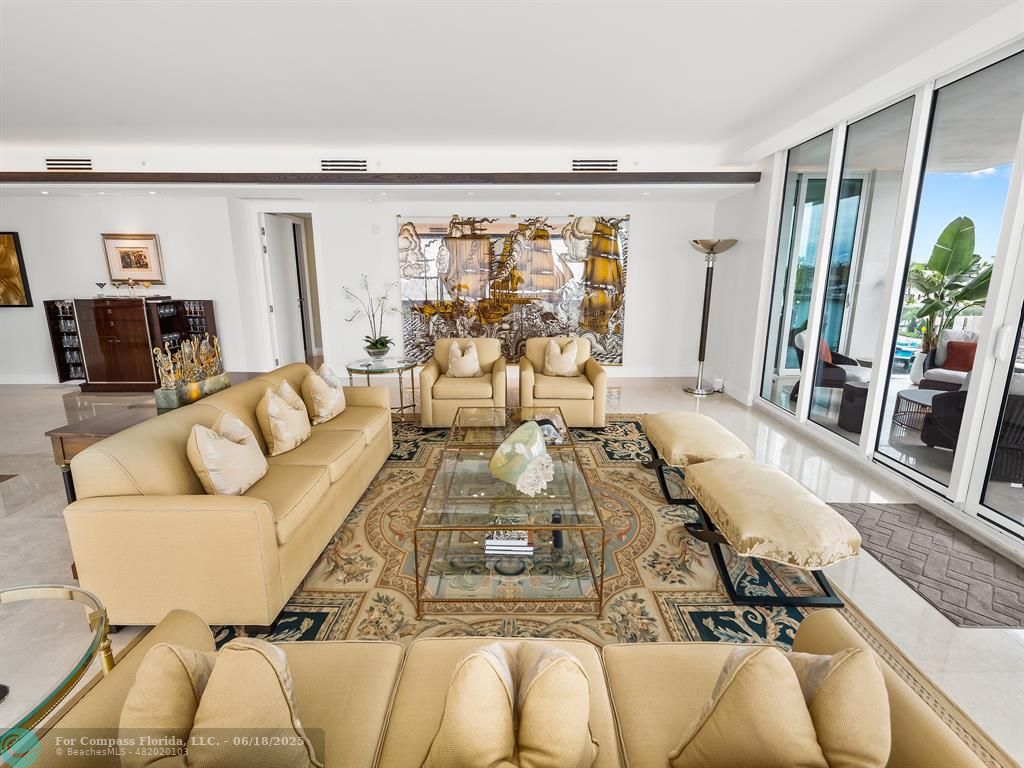 353 Sunset Drive, Unit 401 Fort Lauderdale, FL 33301 - Photo 11 of 43 a living room with furniture and a large window