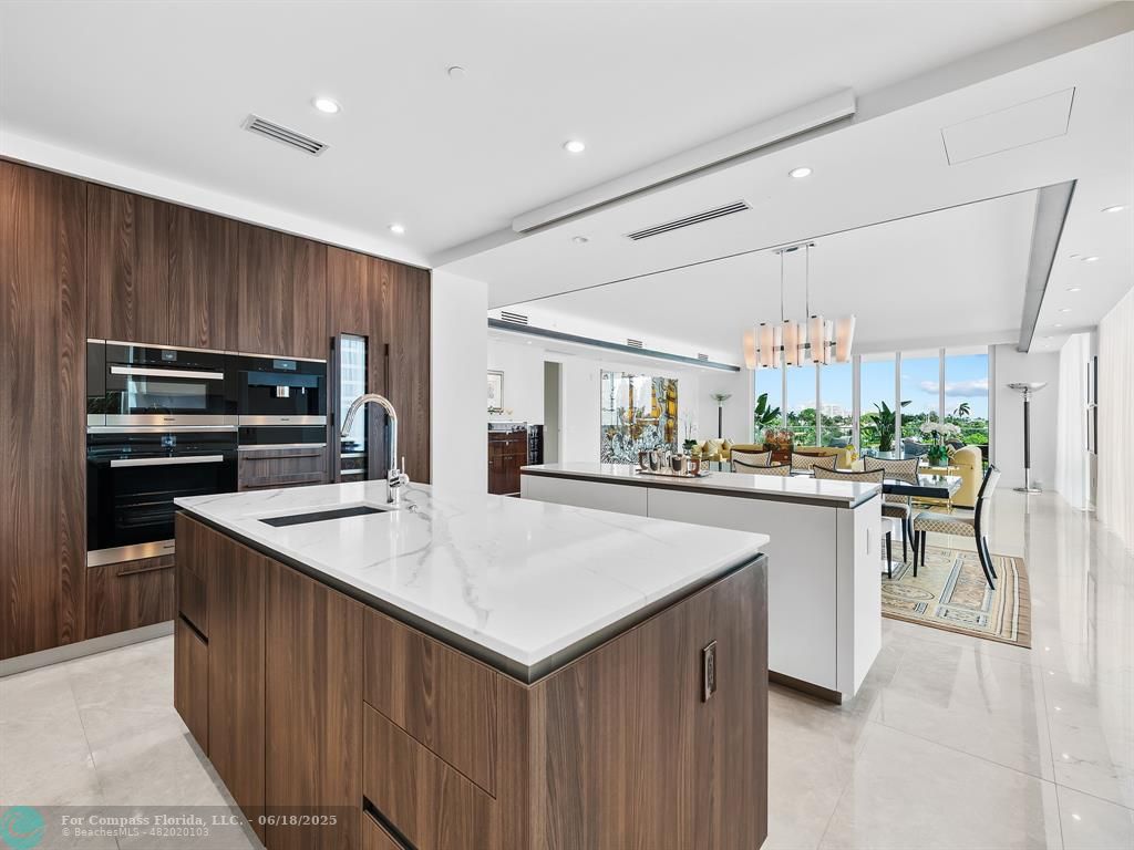 353 Sunset Drive, Unit 401 Fort Lauderdale, FL 33301 - Photo 18 of 43 a kitchen with kitchen island a sink stove and refrigerator