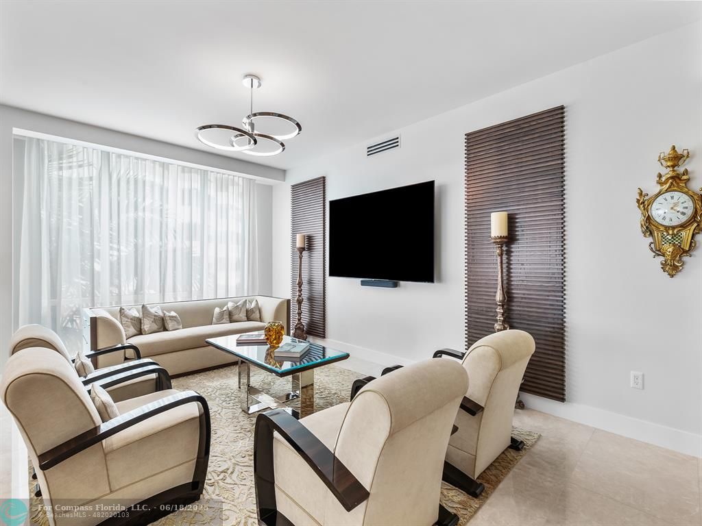 353 Sunset Drive, Unit 401 Fort Lauderdale, FL 33301 - Photo 21 of 43 a living room with furniture a flat screen tv and a window