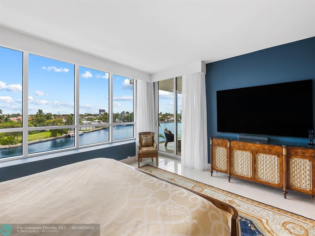 353 Sunset Drive, Unit 401 Fort Lauderdale, FL 33301 - Photo 23 of 43 a living room with large window and a flat screen tv