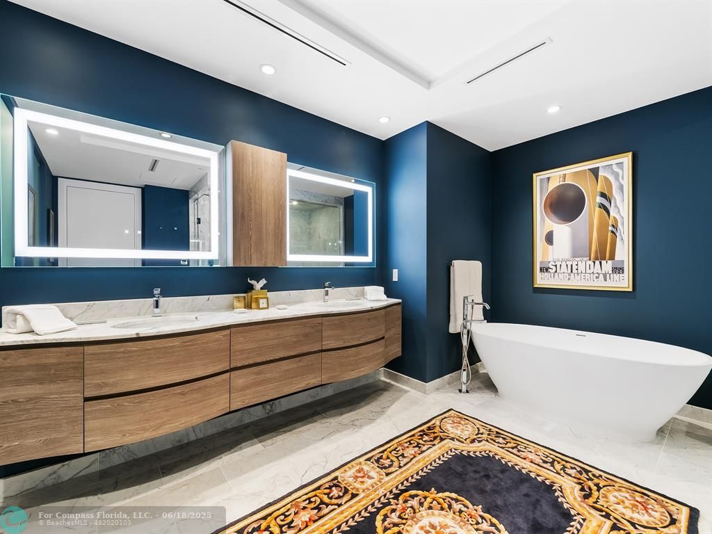 353 Sunset Drive, Unit 401 Fort Lauderdale, FL 33301 - Photo 25 of 43 a spacious bathroom with double vanity sinks and a bathtub