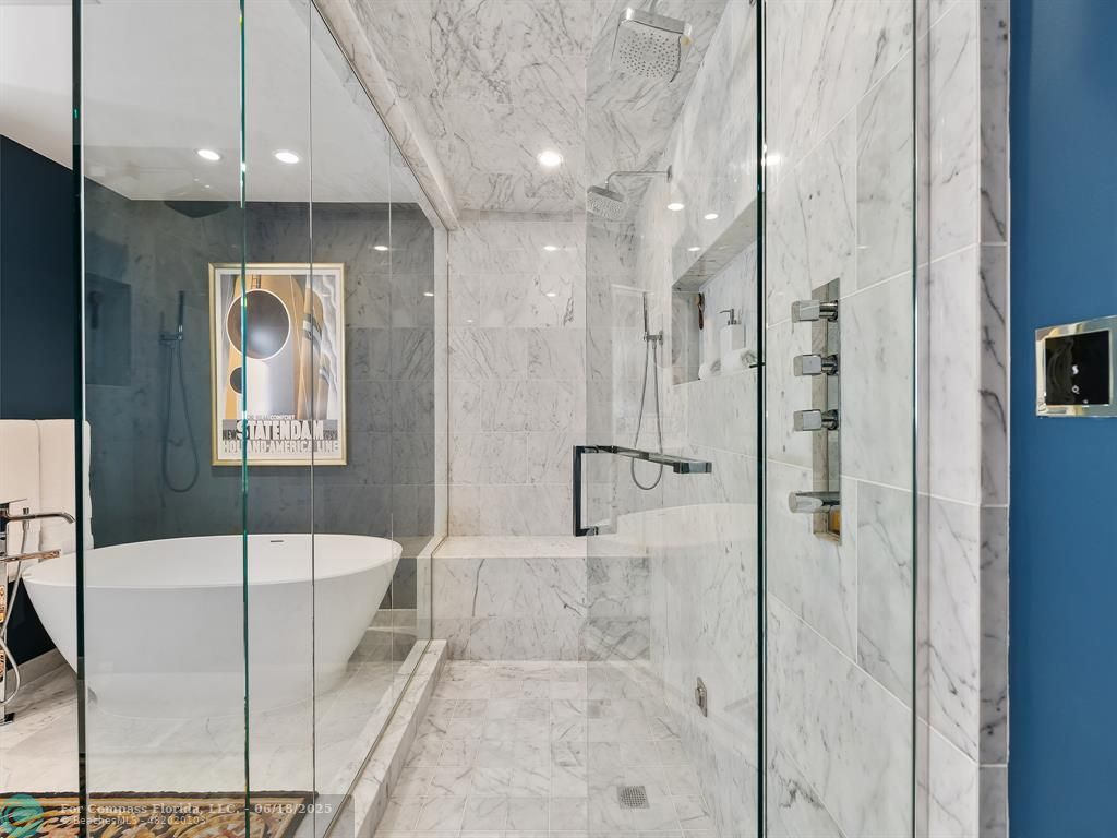 353 Sunset Drive, Unit 401 Fort Lauderdale, FL 33301 - Photo 27 of 43 a bathroom with a tub and shower