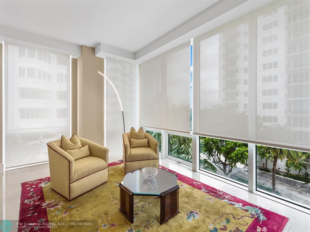 353 Sunset Drive, Unit 401 Fort Lauderdale, FL 33301 - Photo 28 of 43 a living room with furniture and a floor to ceiling window