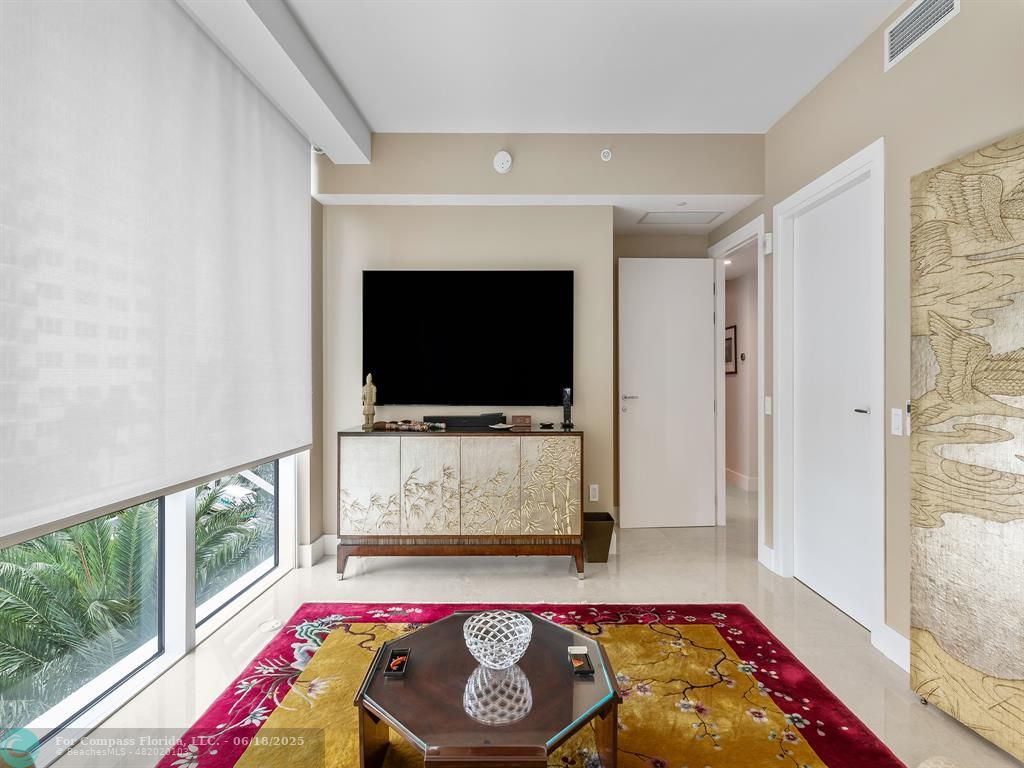 353 Sunset Drive, Unit 401 Fort Lauderdale, FL 33301 - Photo 29 of 43 a living room with furniture and a flat screen tv