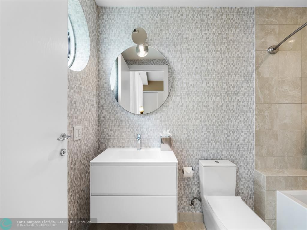 353 Sunset Drive, Unit 401 Fort Lauderdale, FL 33301 - Photo 32 of 43 a white toilet sitting next to a bathroom sink