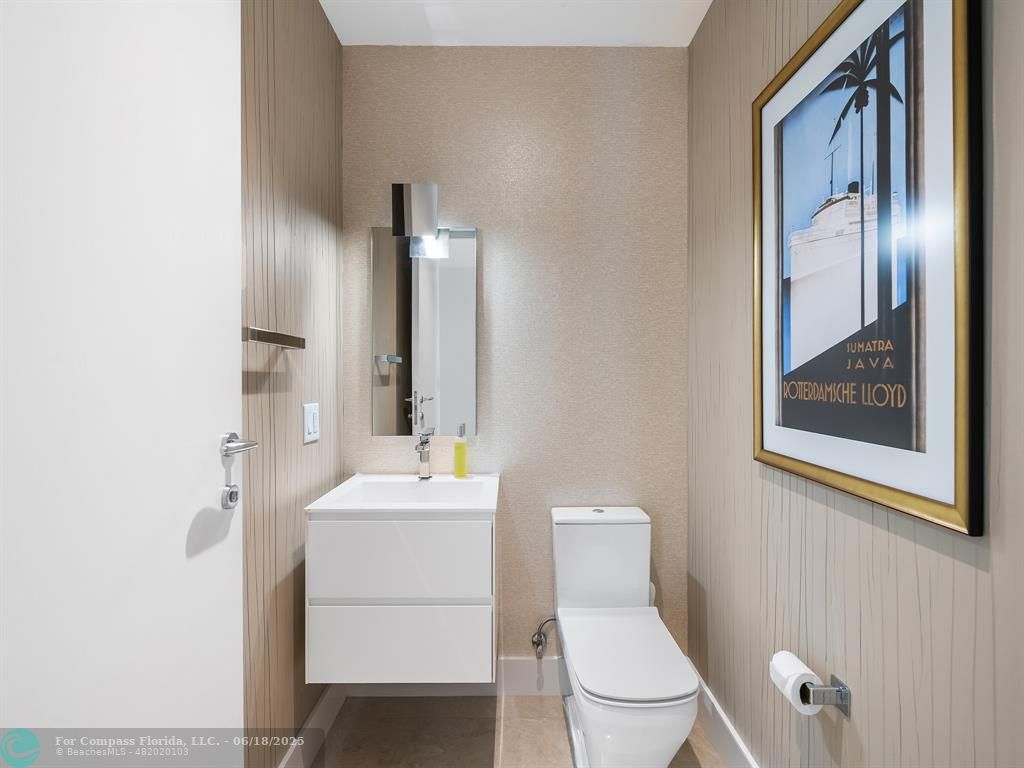 353 Sunset Drive, Unit 401 Fort Lauderdale, FL 33301 - Photo 36 of 43 a bathroom with a toilet a sink and mirror