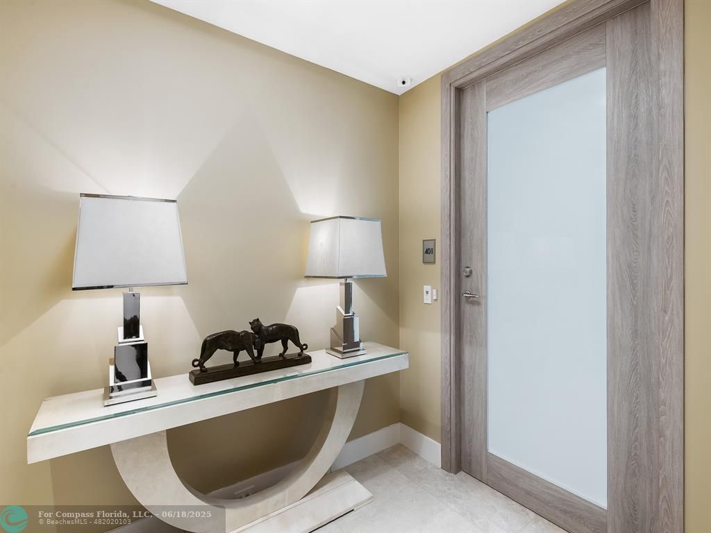 353 Sunset Drive, Unit 401 Fort Lauderdale, FL 33301 - Photo 6 of 43 a table with a lamp