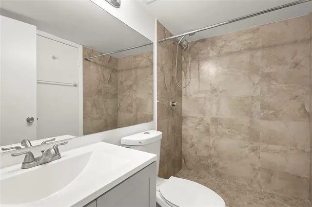 an empty room with closet and fan