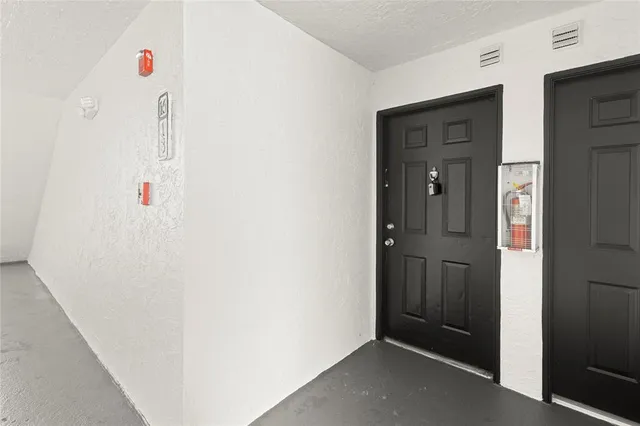 a view of a kitchen with a sink and dishwasher a fireplace with wooden floor