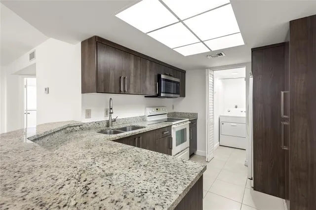 a kitchen with a sink cabinets and stainless steel appliances