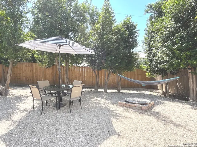 a patio with a table and chairs