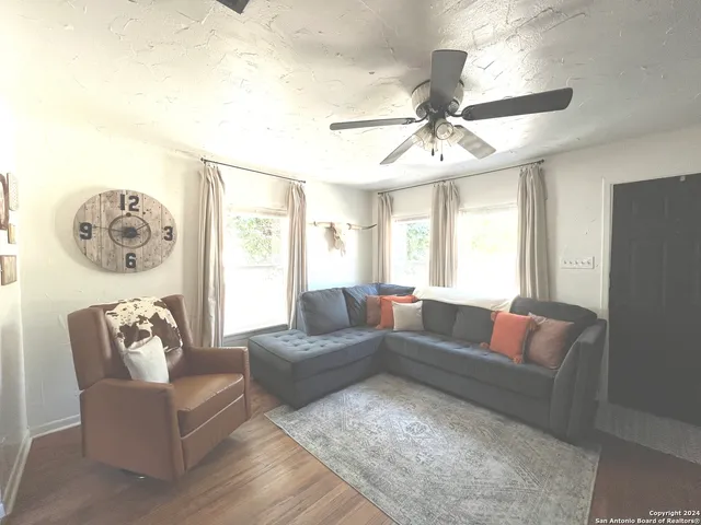 a living room with furniture and a large window
