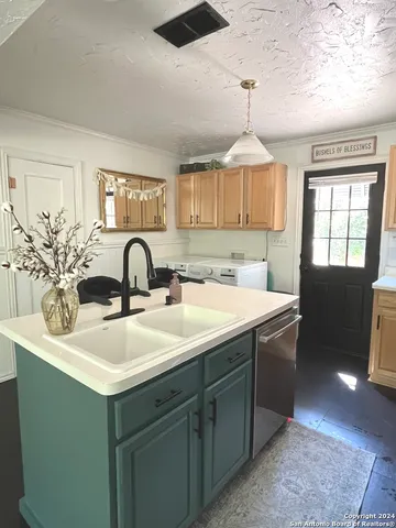a kitchen with a sink and a chandelier