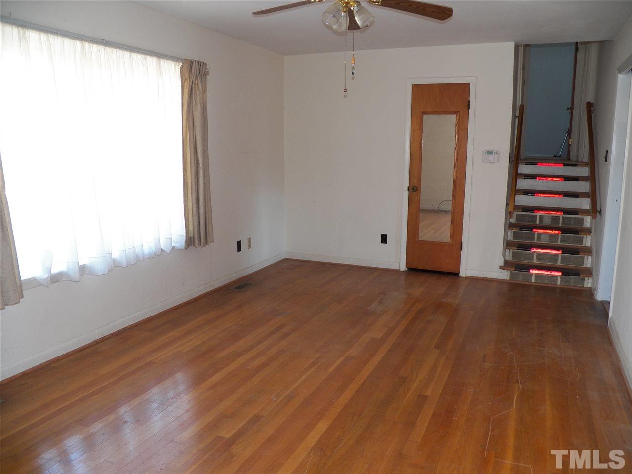 124 East Rowan Street Raleigh, NC 27609 - Photo 2 of 18 an empty room with wooden floor closet and windows