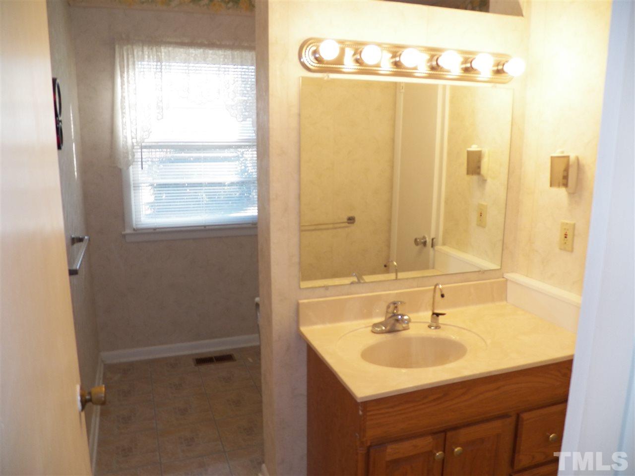 124 East Rowan Street Raleigh, NC 27609 - Photo 14 of 18 a bathroom with a sink and a mirror