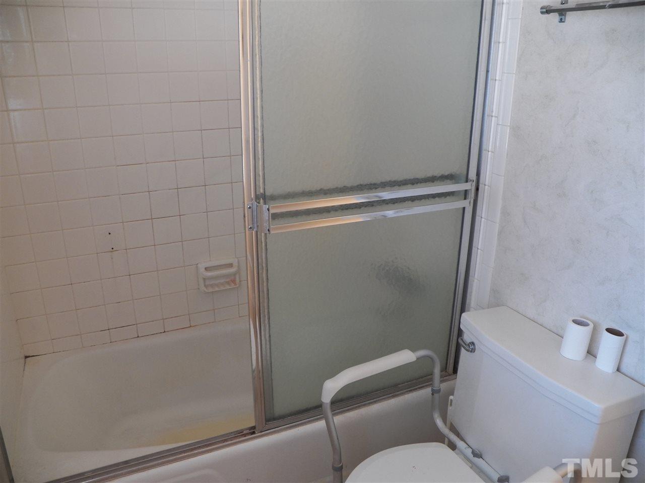 124 East Rowan Street Raleigh, NC 27609 - Photo 15 of 18 a bathroom with a toilet and shower