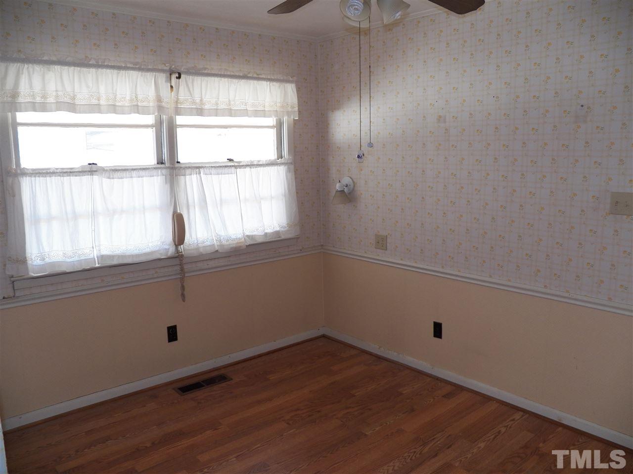 124 East Rowan Street Raleigh, NC 27609 - Photo 5 of 18 an empty room with wooden floor and windows