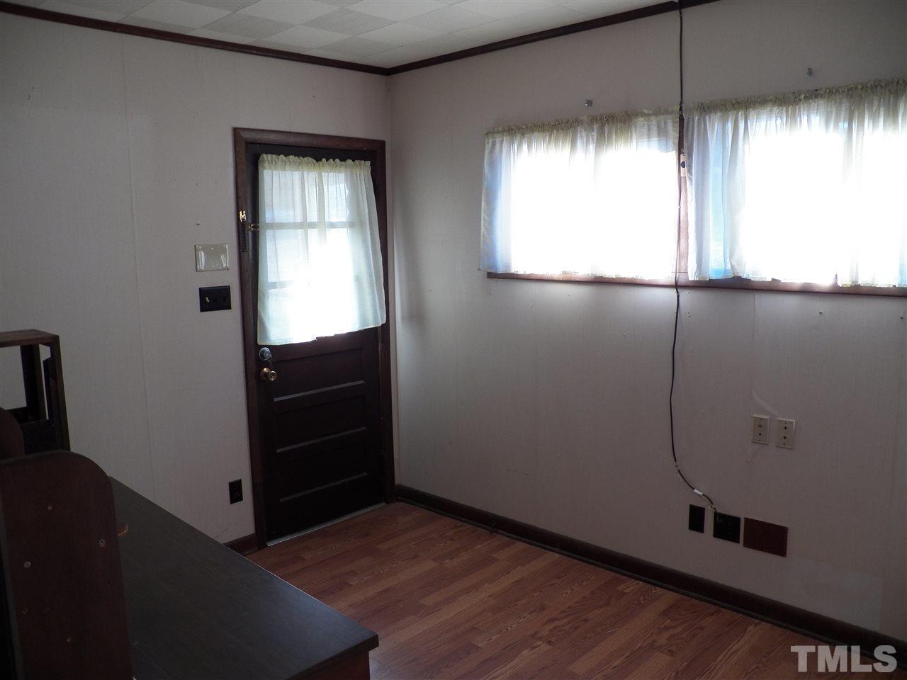124 East Rowan Street Raleigh, NC 27609 - Photo 6 of 18 an empty room with windows and cabinet