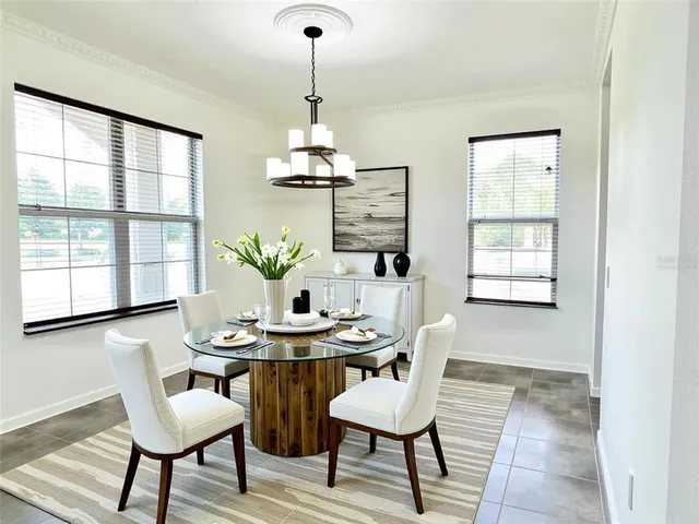 a view of a dining room with furniture and window