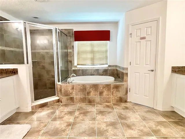 a view of a room with wooden floor and a floor to ceiling window next to a yard