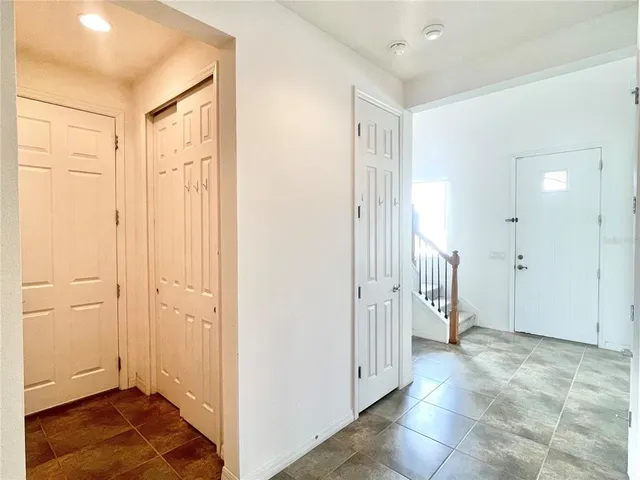 a view of a hallway with wooden floor and entryway