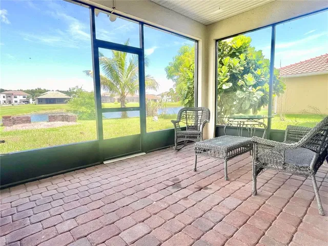 a living room with furniture and floor to ceiling windows