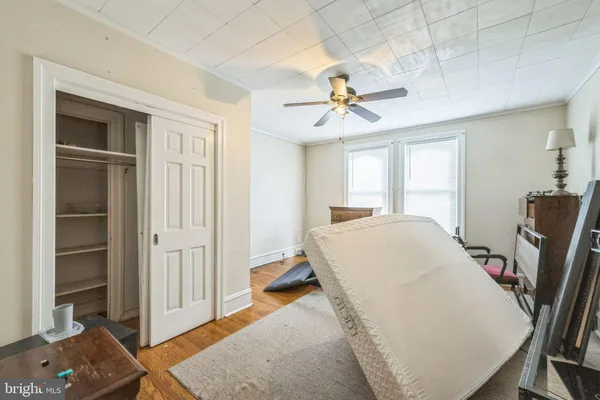a bedroom with a bed closet and a window