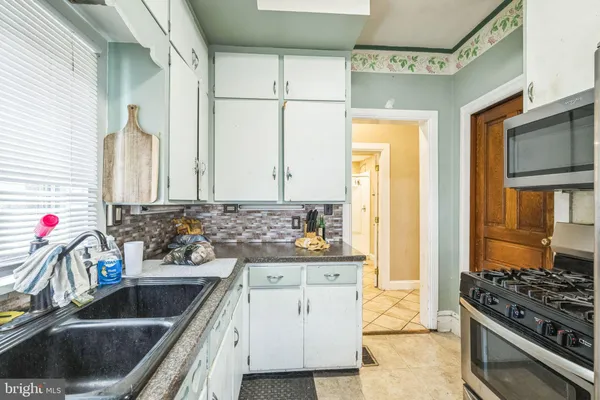a kitchen with a sink stove and refrigerator