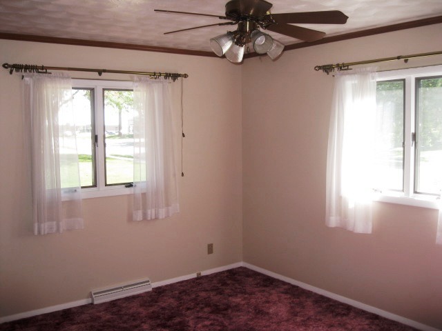 215 Linder Lane Rochelle, IL 61068 - Photo 17 of 19 an empty room with a window and a fan