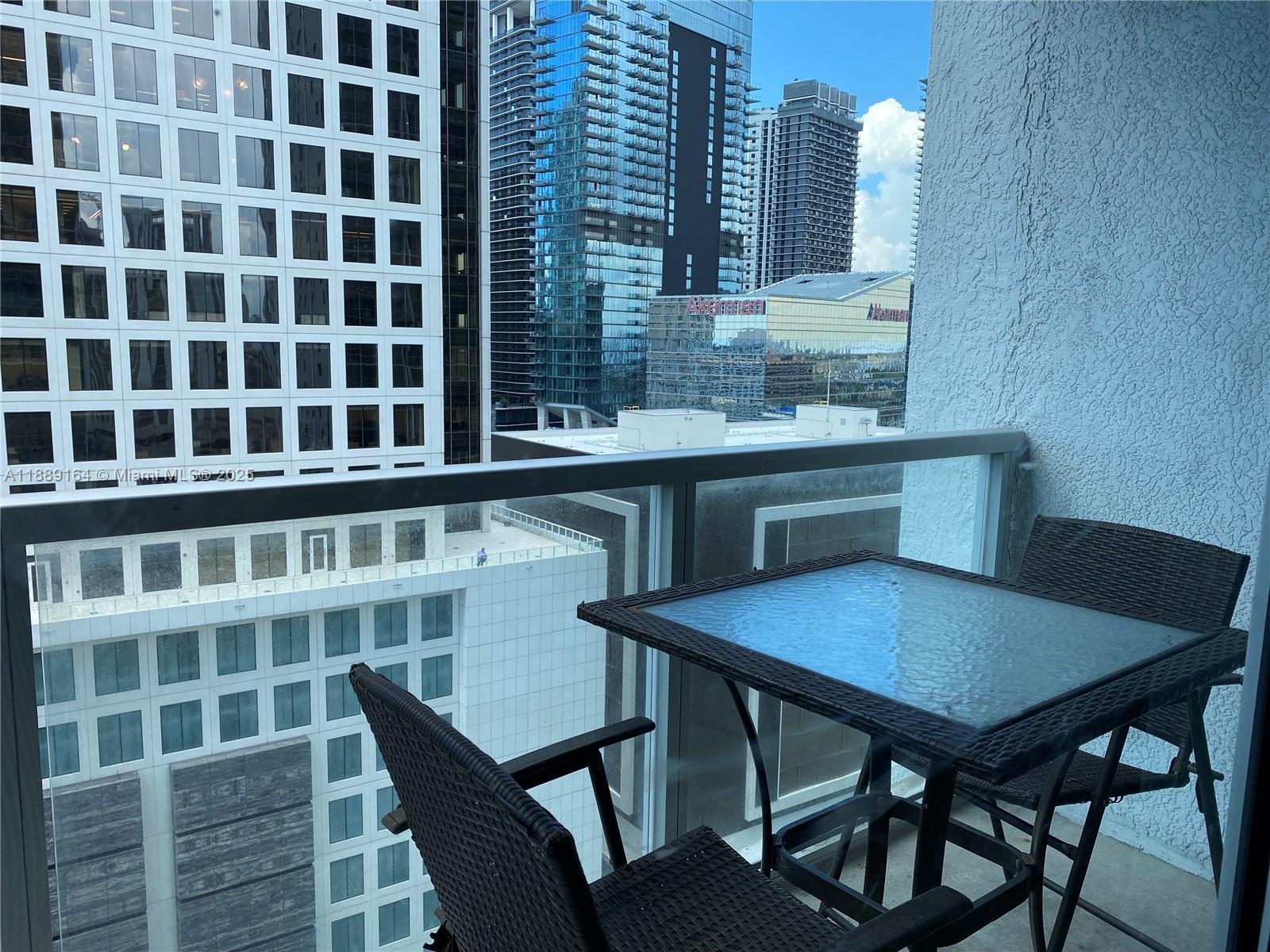 500 Brickell Avenue, Unit 1908 Miami, FL 33131 - Photo 8 of 13 a view of a dining room with furniture and wooden floor
