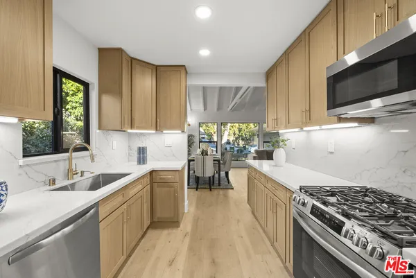 a kitchen with a sink stove and microwave