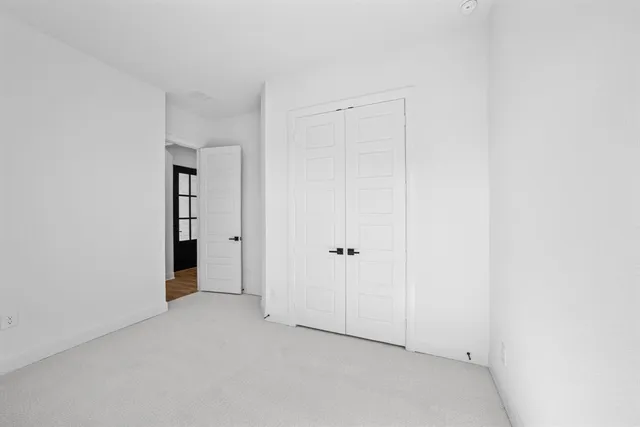 a view of walk in closet with empty racks
