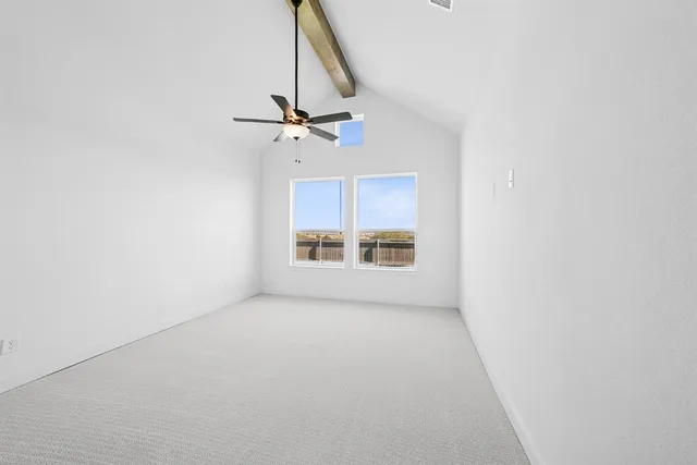 an empty room with a window and a ceiling fan