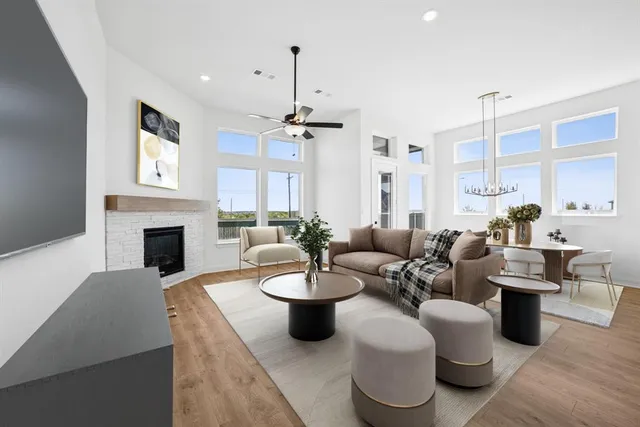 a view of empty room with a fireplace and wooden floor
